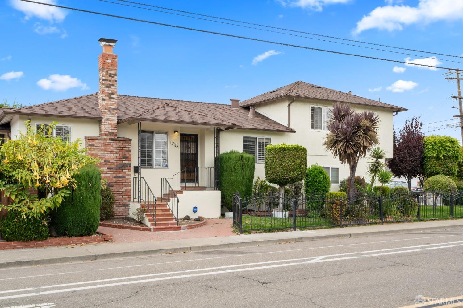 a front view of a house with garden