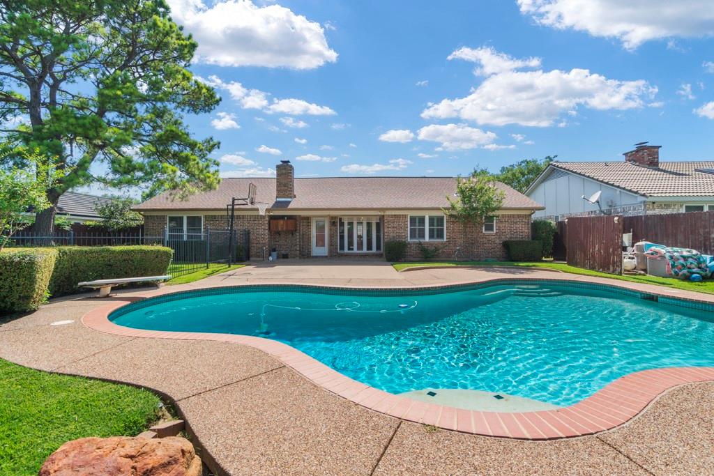 a view of a swimming pool with a patio