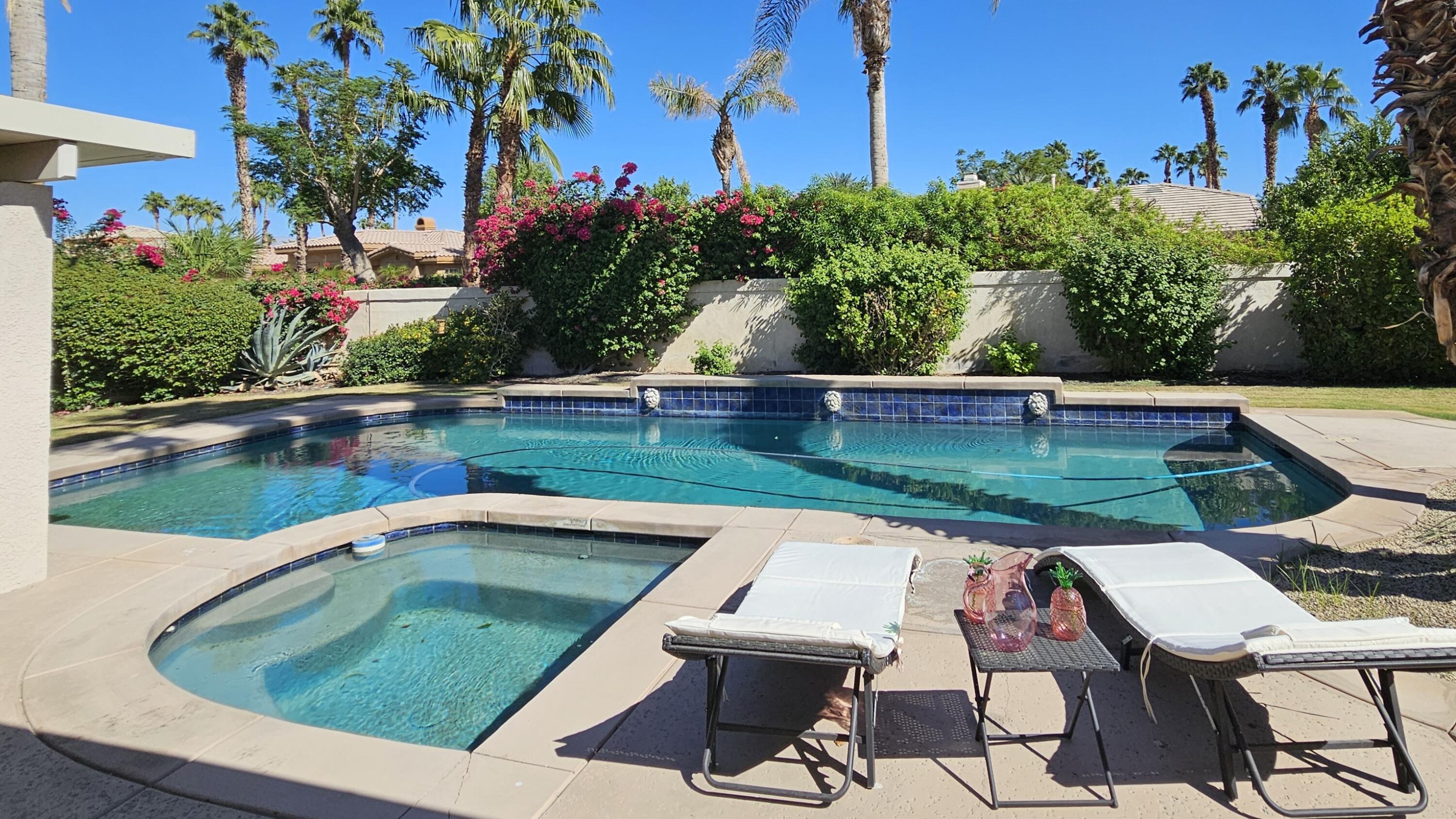 swimming pool view with a seating space