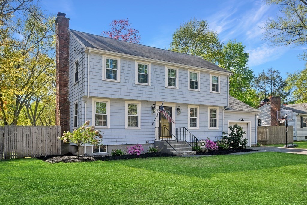 a front view of a house with a garden