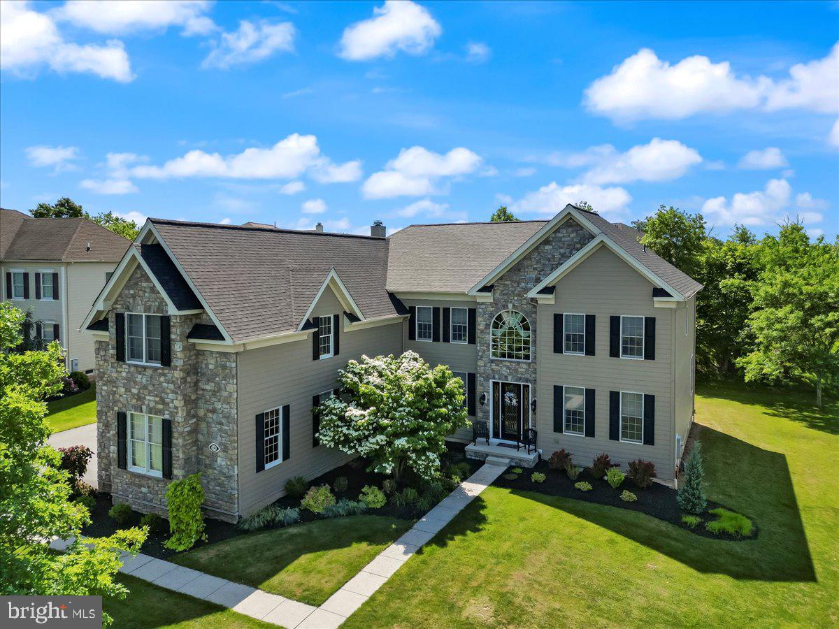 a aerial view of a house next to a yard