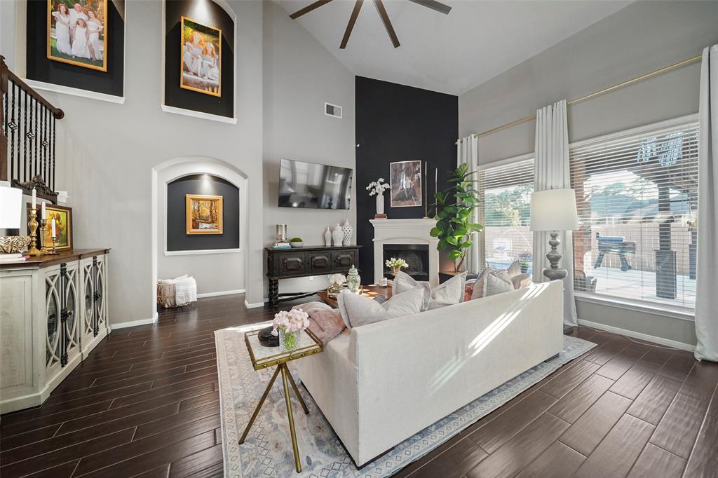 Another view of the living room with large windows overlooking the pool and back porch.