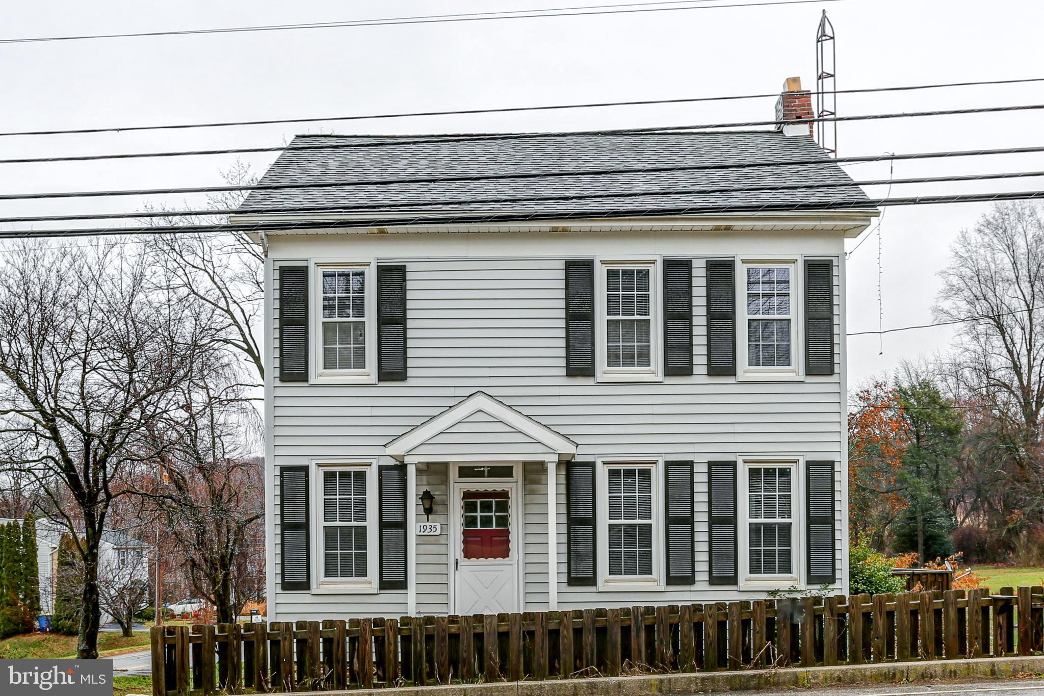 a view of a house with large windows and a small yard