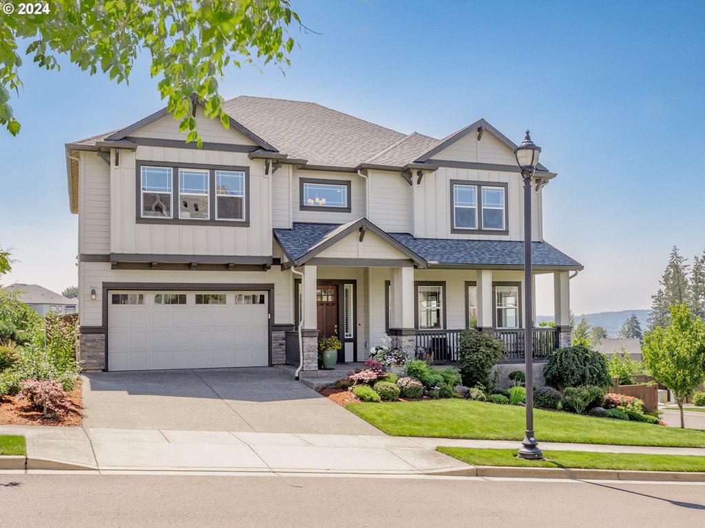 a front view of a house with a yard and garage