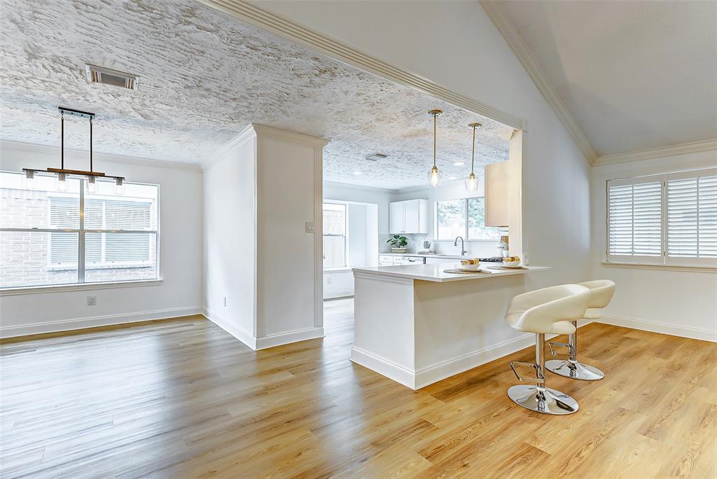 a living room with kitchen island granite countertop furniture and a large window