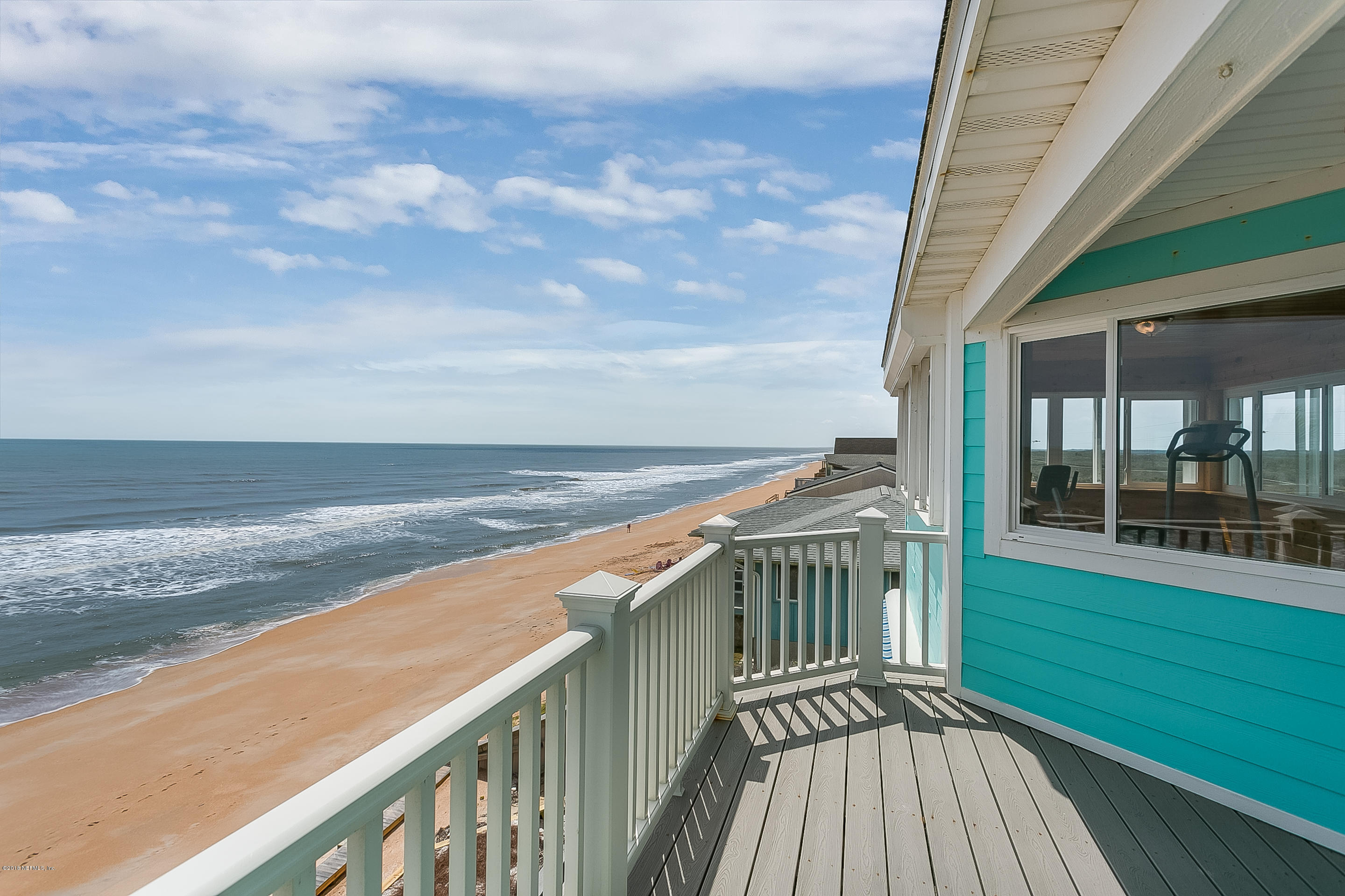 a view of a balcony with wooden floor and city view