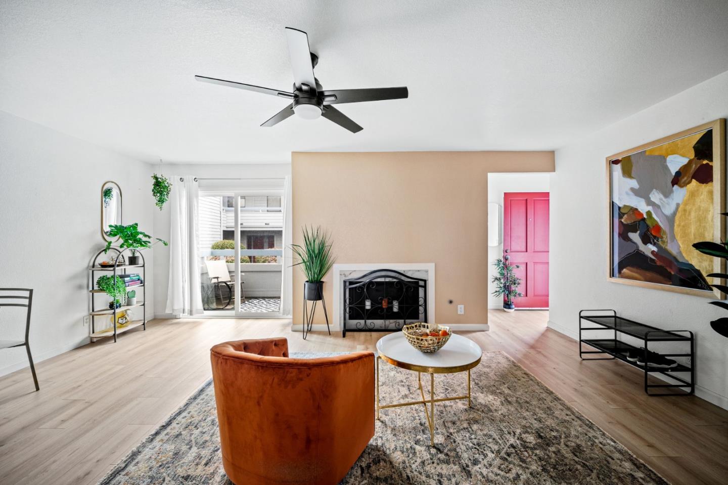 a living room with furniture a flat screen tv and a fireplace