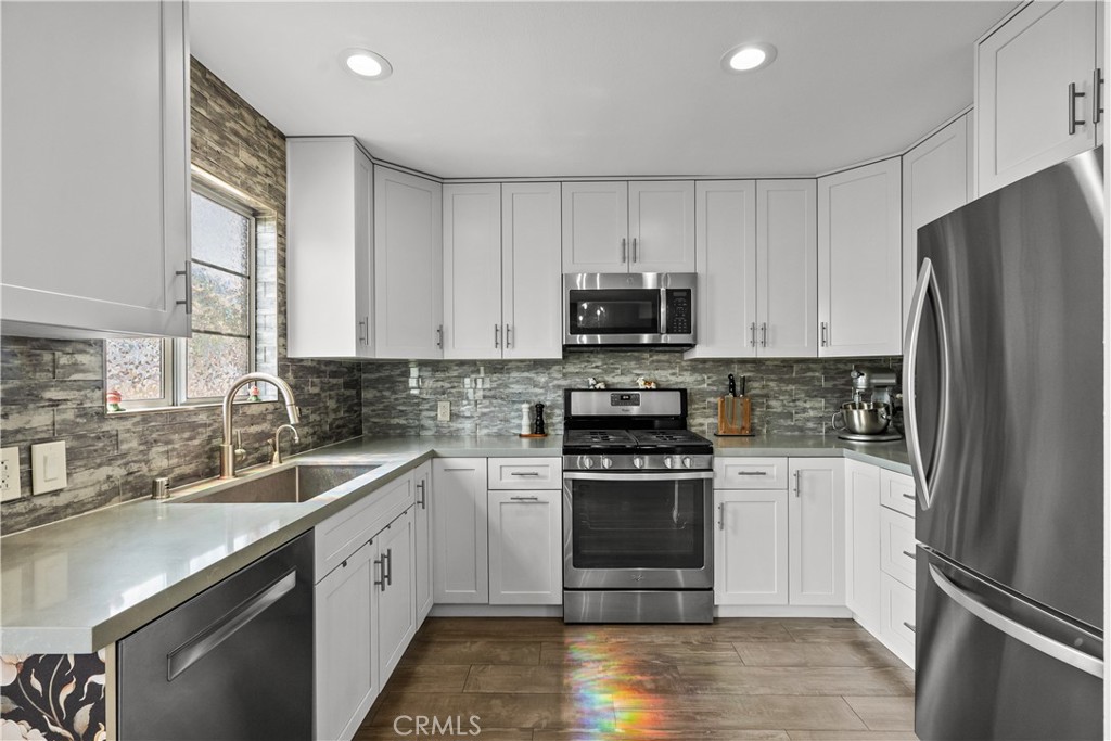 a kitchen with a sink stove and refrigerator