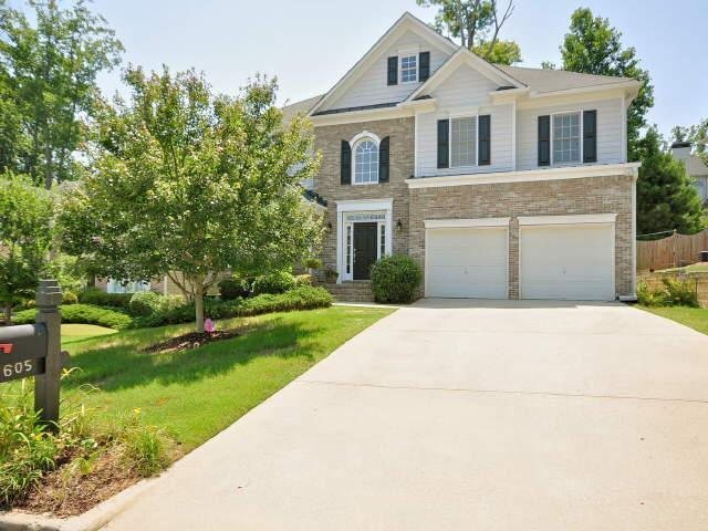 a front view of a house with a yard