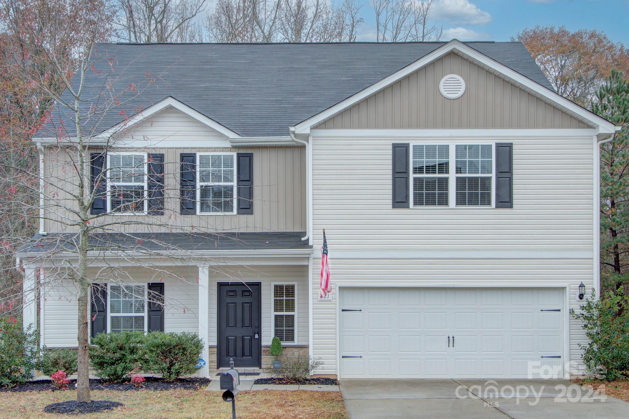 a front view of a house with garage