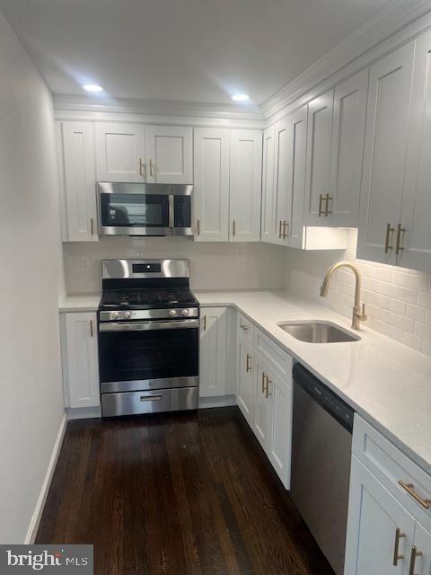 a kitchen with a sink and a stove top oven