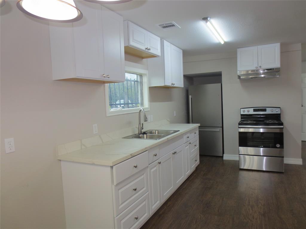 a kitchen with a sink and stainless steel appliances