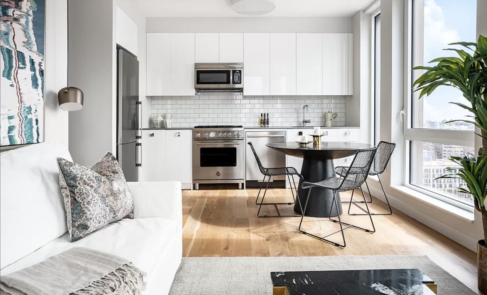 a kitchen with stainless steel appliances kitchen island granite countertop a sink and a stove top oven