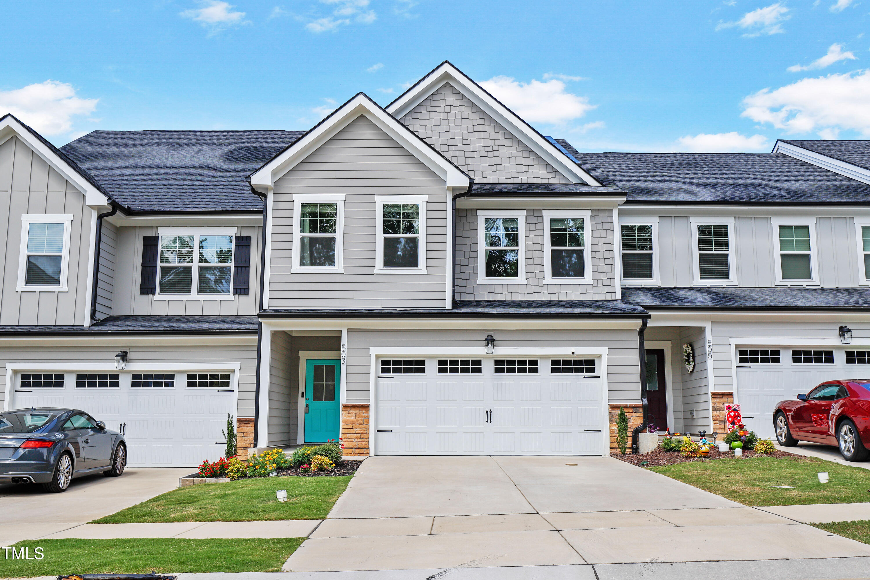 a front view of a house with a yard and garage