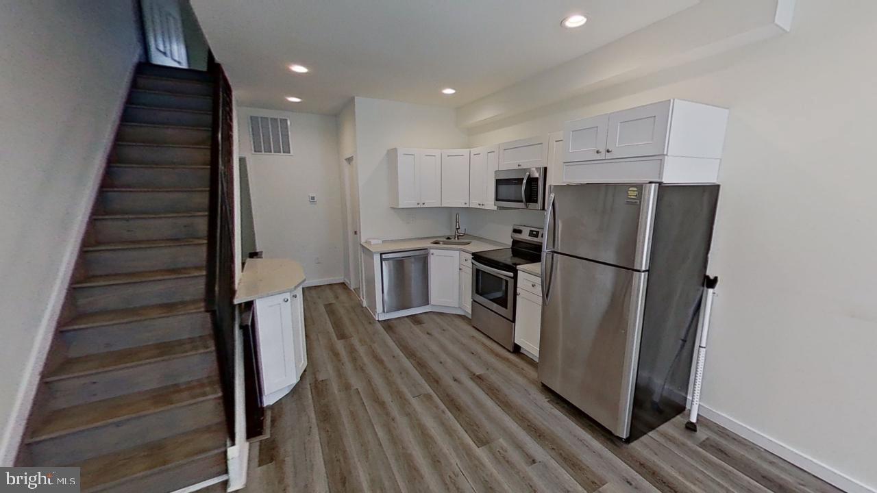 a view of kitchen with cabinets and stainless steel appliances