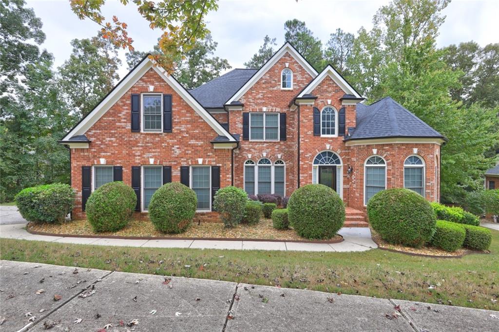 a front view of a house with a yard