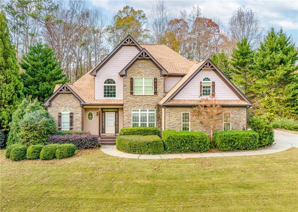 a front view of a house with a yard and garage