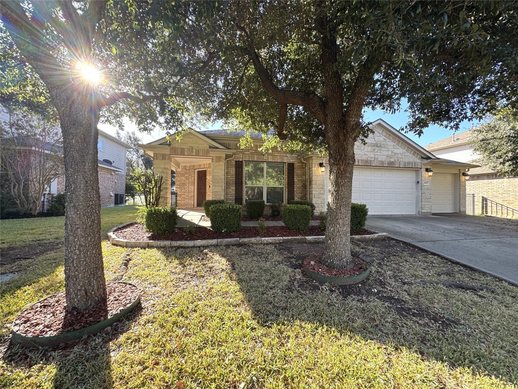 a front view of a house with a yard and trees