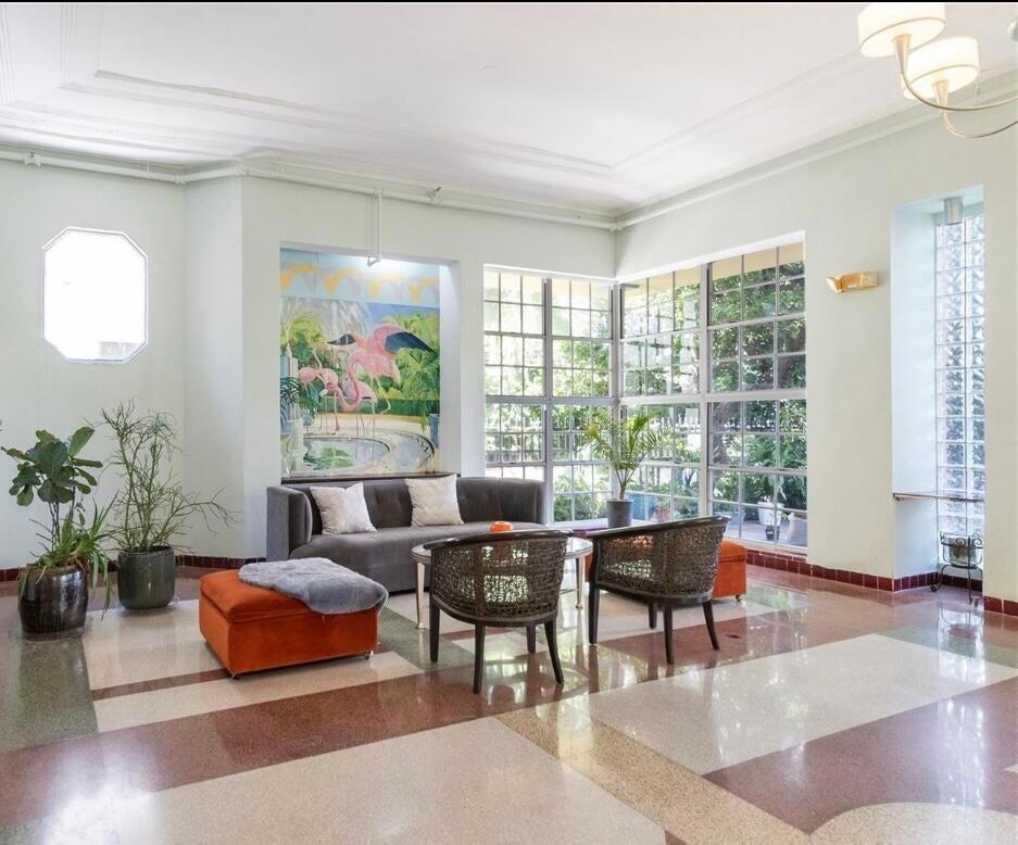 a living room with furniture and a large window