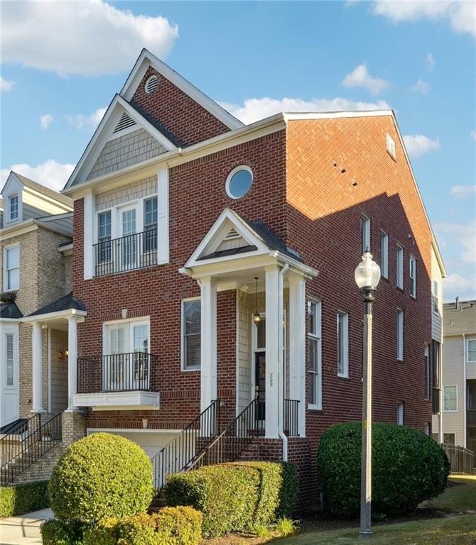 a view of a brick house with a yard and plants