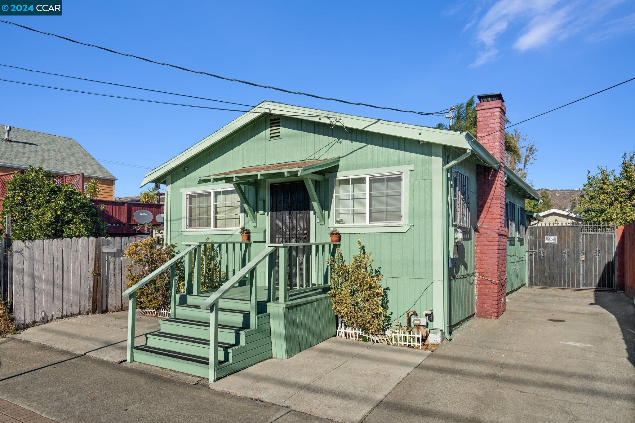 a front view of a house with plants