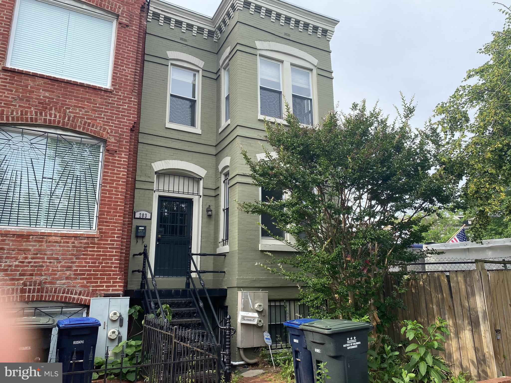 a front view of a house with plants