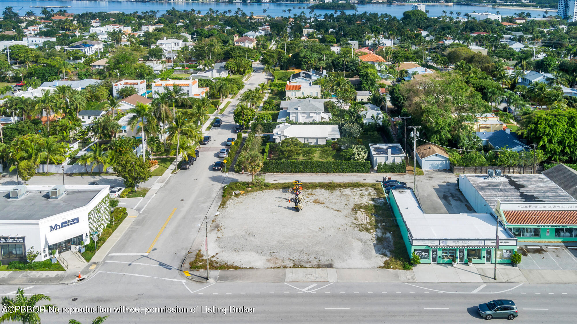 an aerial view of residential houses with outdoor space and parking