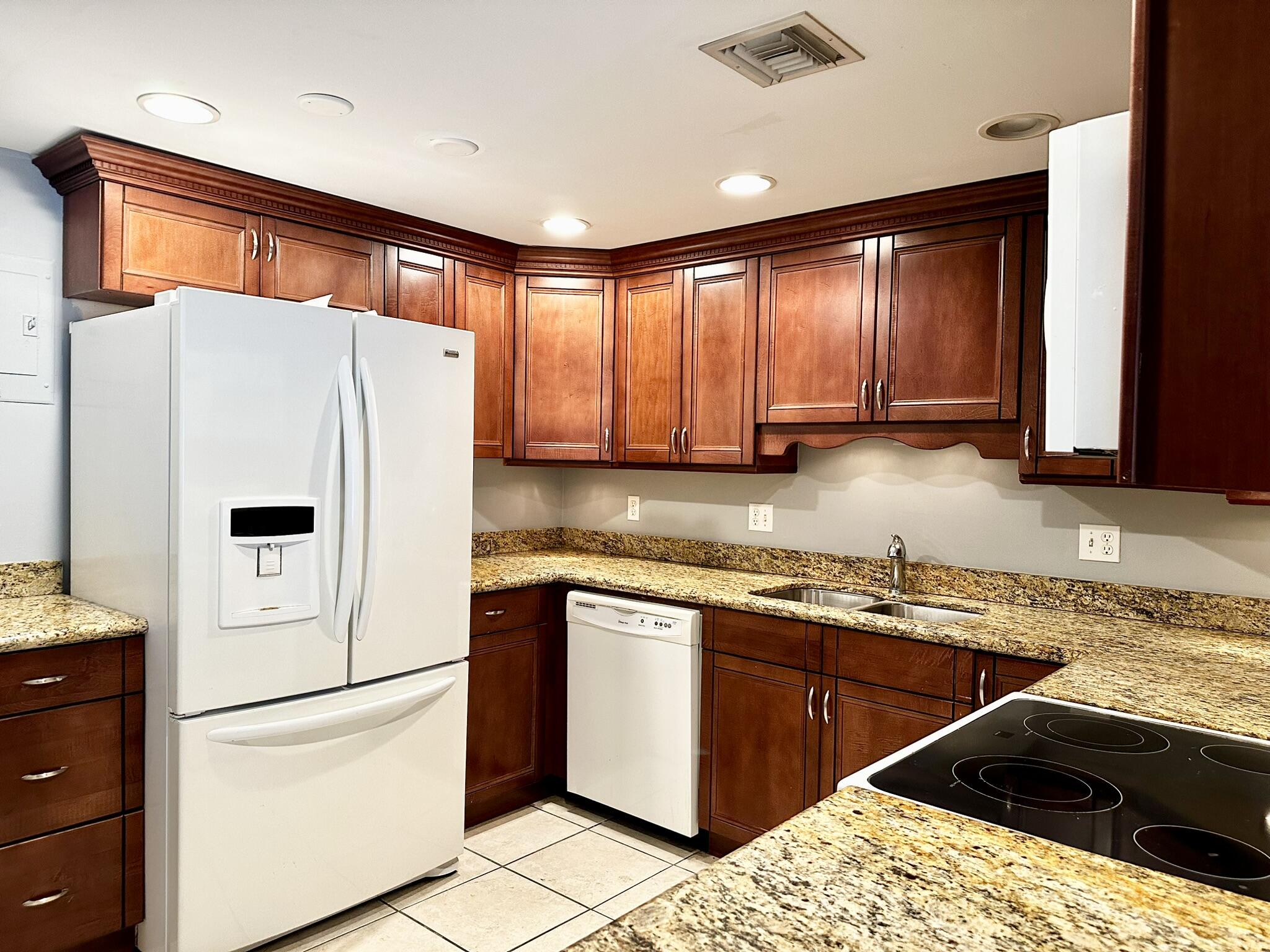 a white refrigerator freezer sitting inside of a kitchen