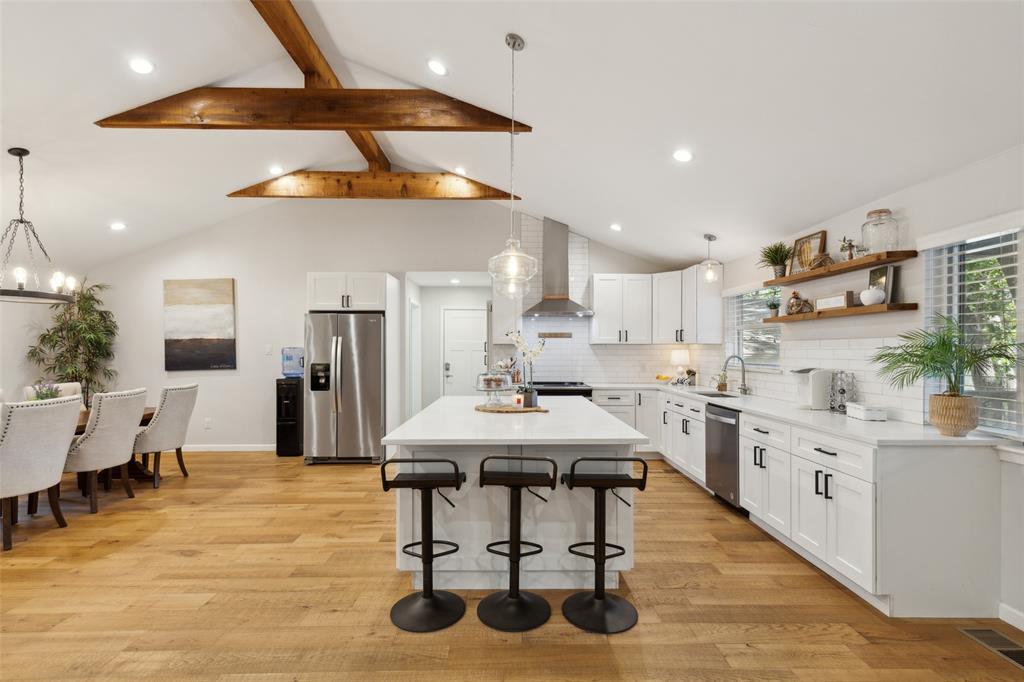 a large kitchen with a table and chairs in it