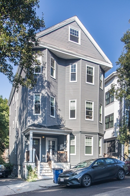 a front view of a residential apartment building with a yard