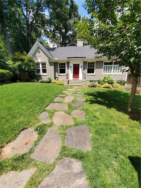 a front view of a house with garden