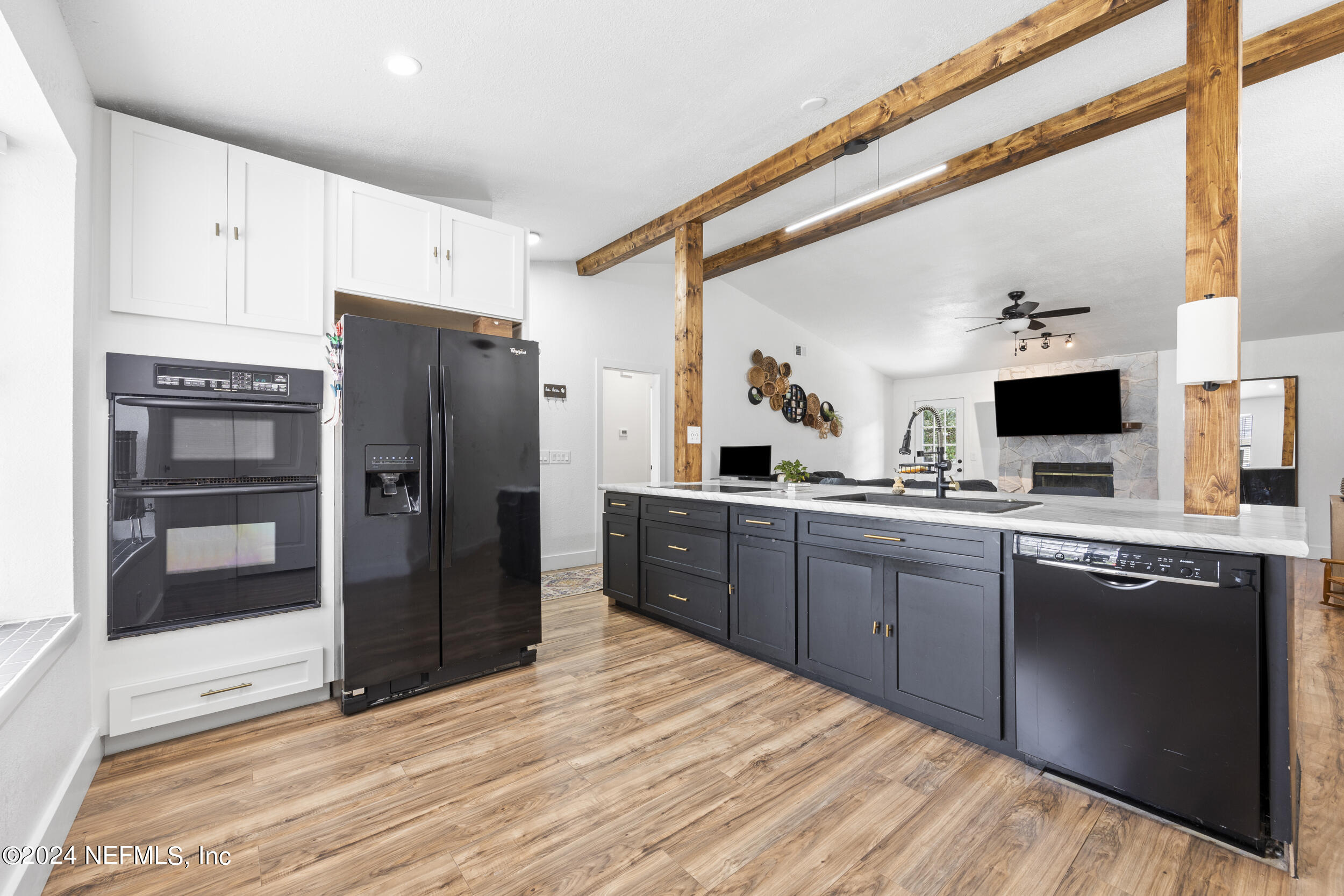 a kitchen with stainless steel appliances granite countertop a refrigerator and a sink