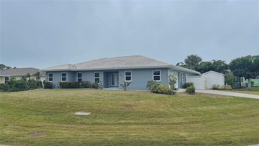 a front view of house with yard and car parked