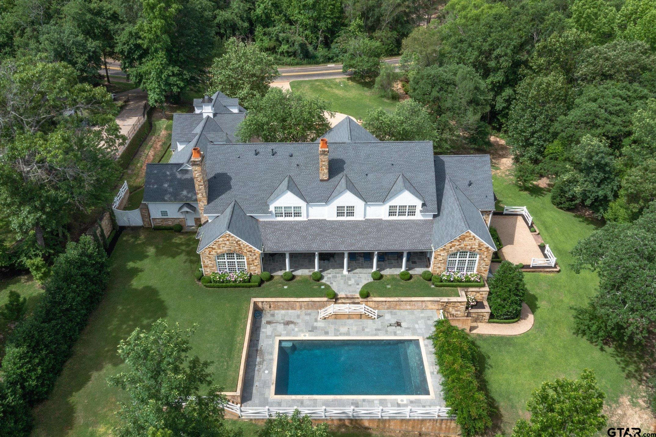 an aerial view of a house with swimming pool patio and outdoor seating