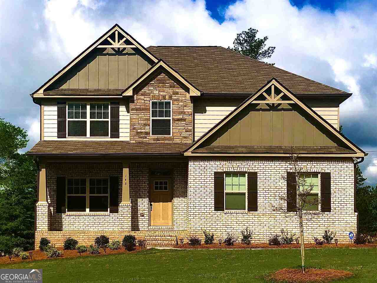 a front view of a house with a yard