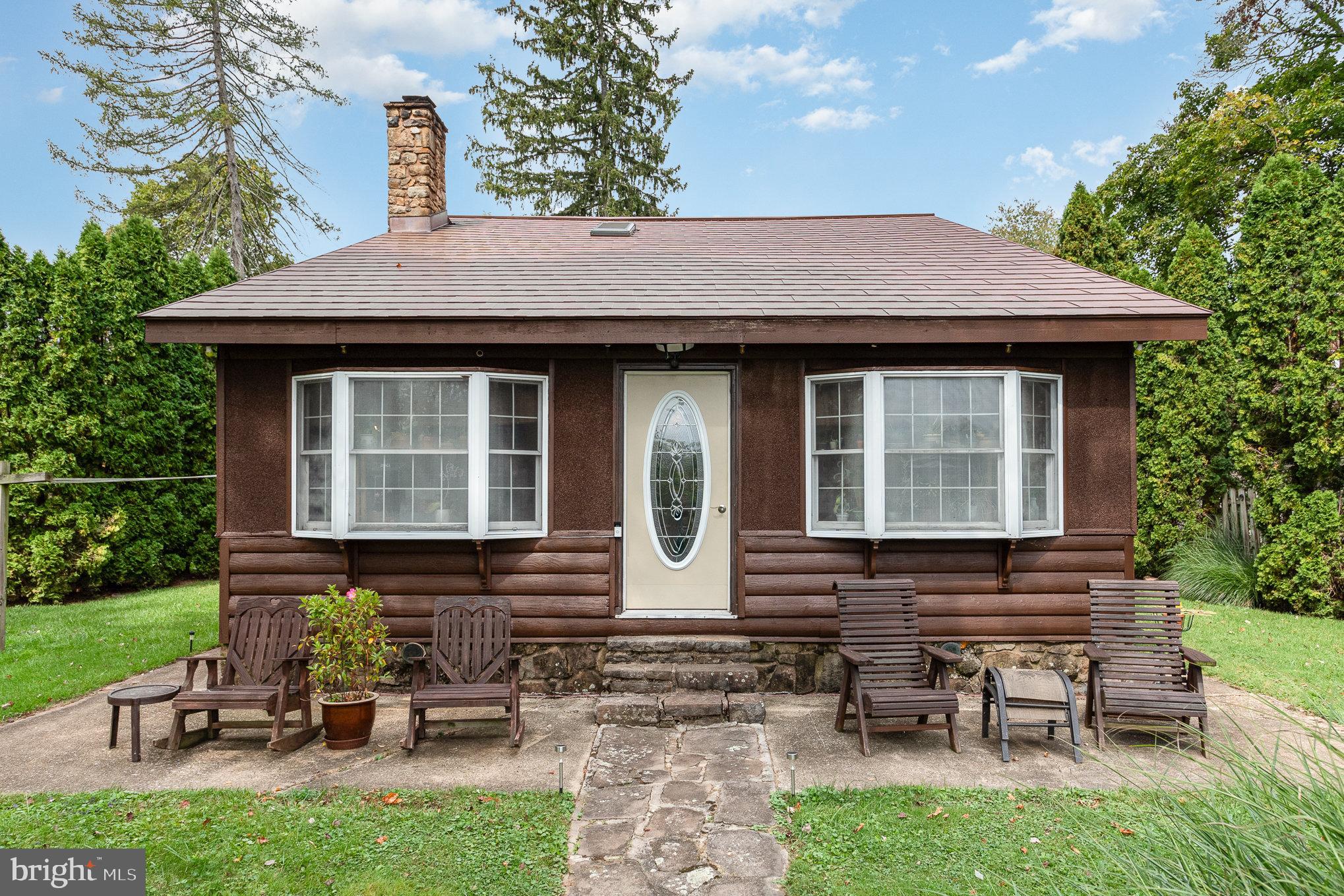 a view of a house with a yard chairs and table in patio