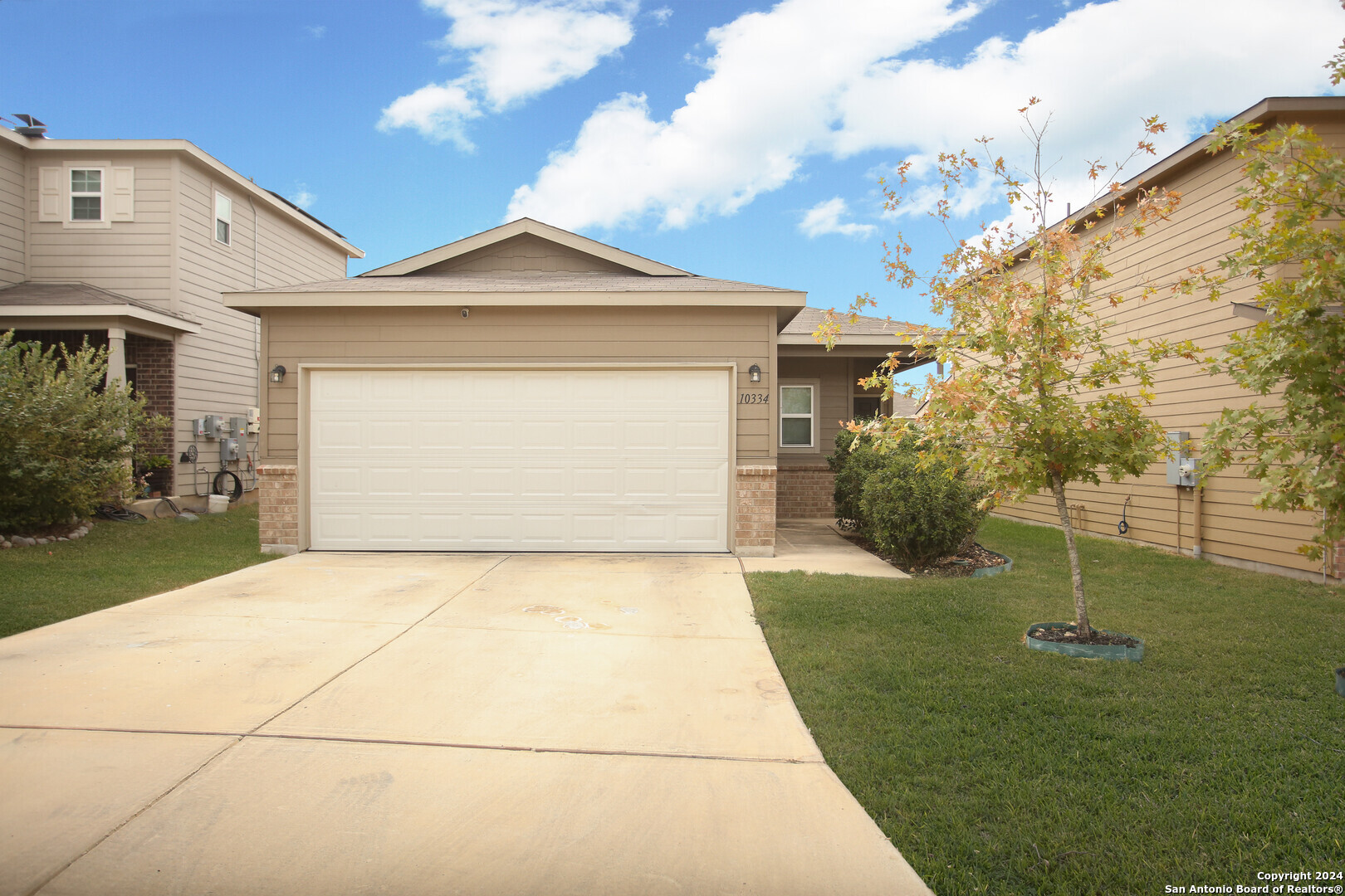 a front view of a house with a yard