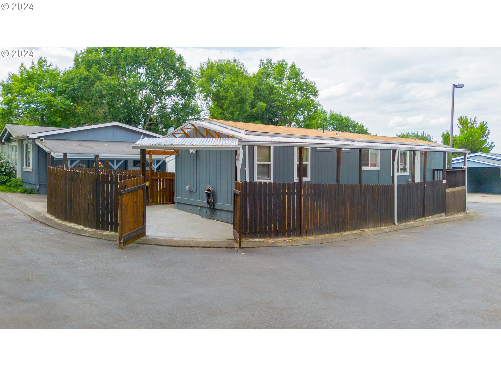 a backyard of a house with wooden floor and fence