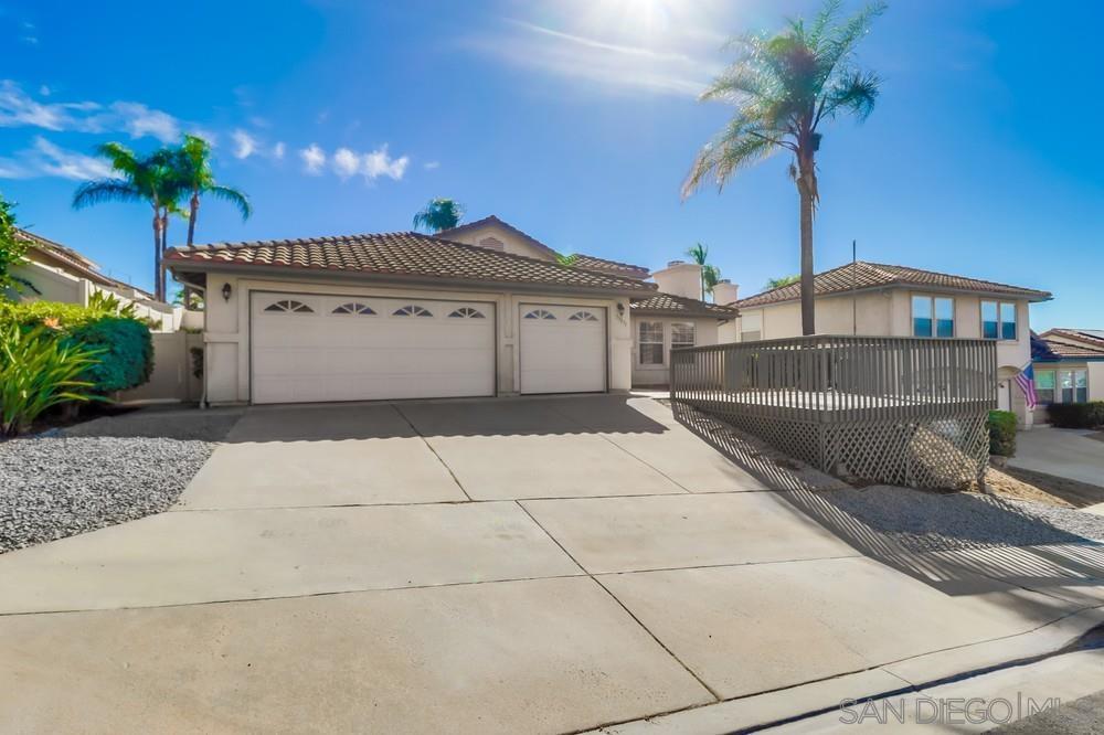 a view of a house with a yard and potted plants