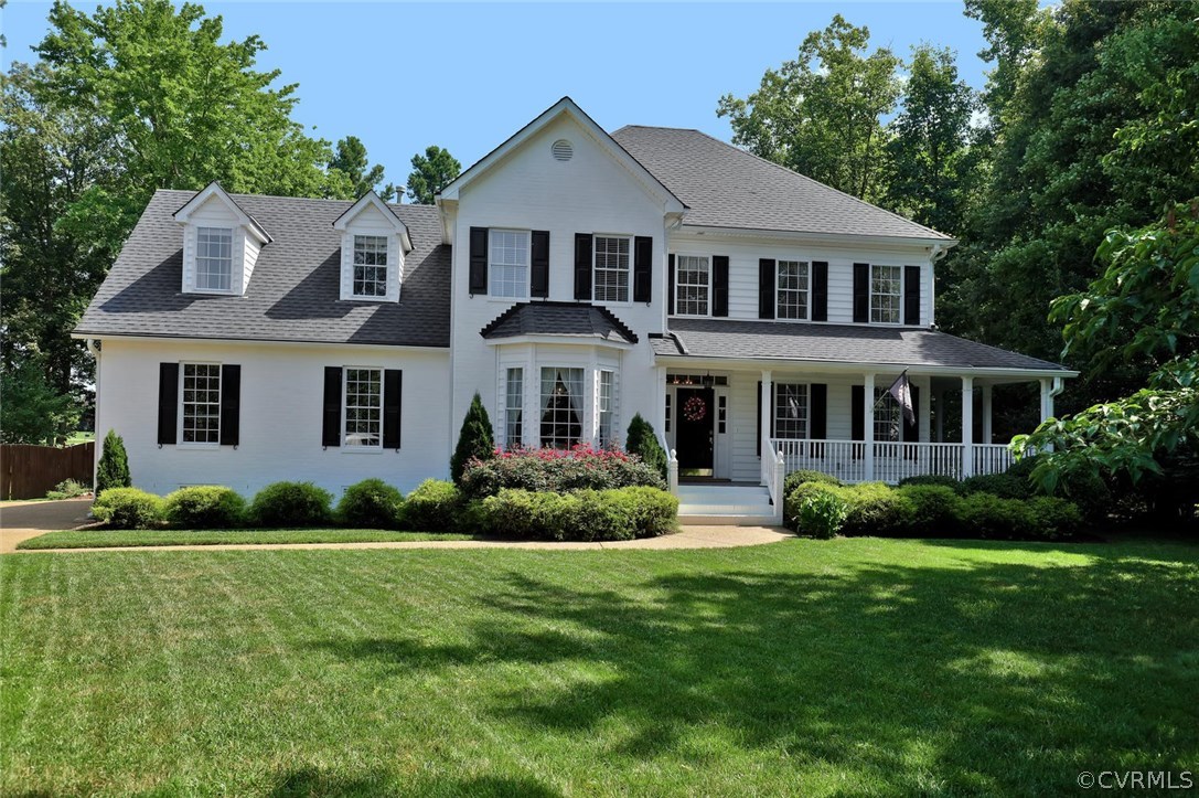 a front view of a house with a garden and plants