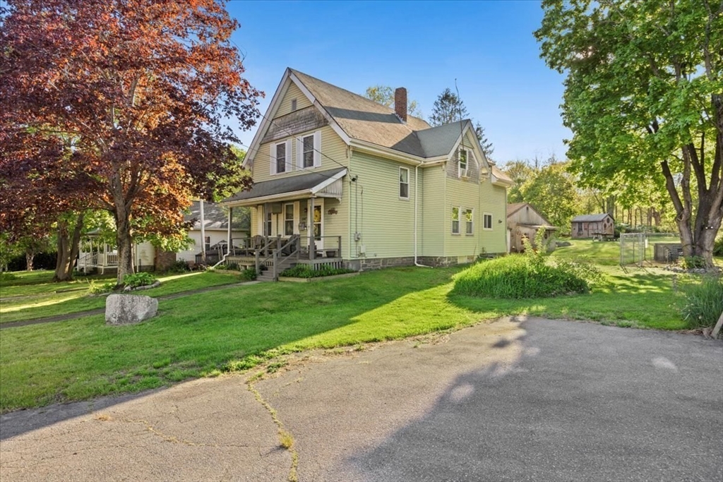 a front view of house with yard and green space