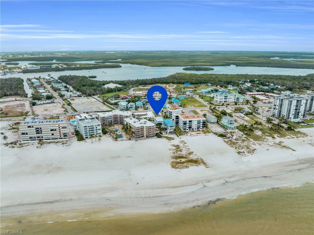 Drone / aerial view with a water view and a view of the beach