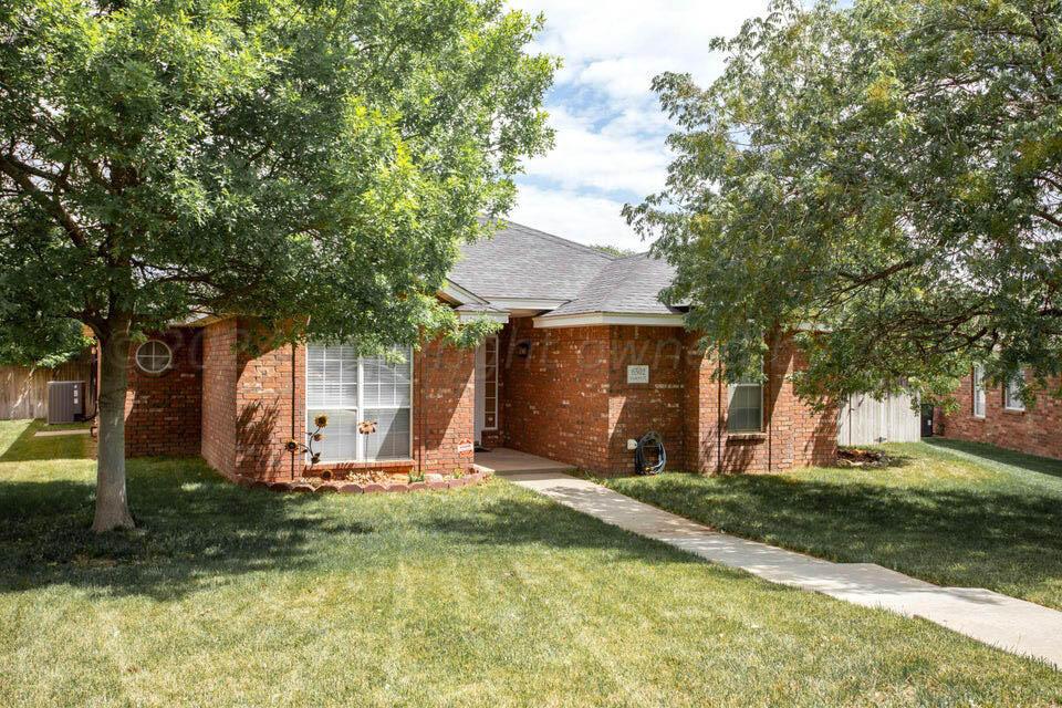 a view of a house with yard and tree s