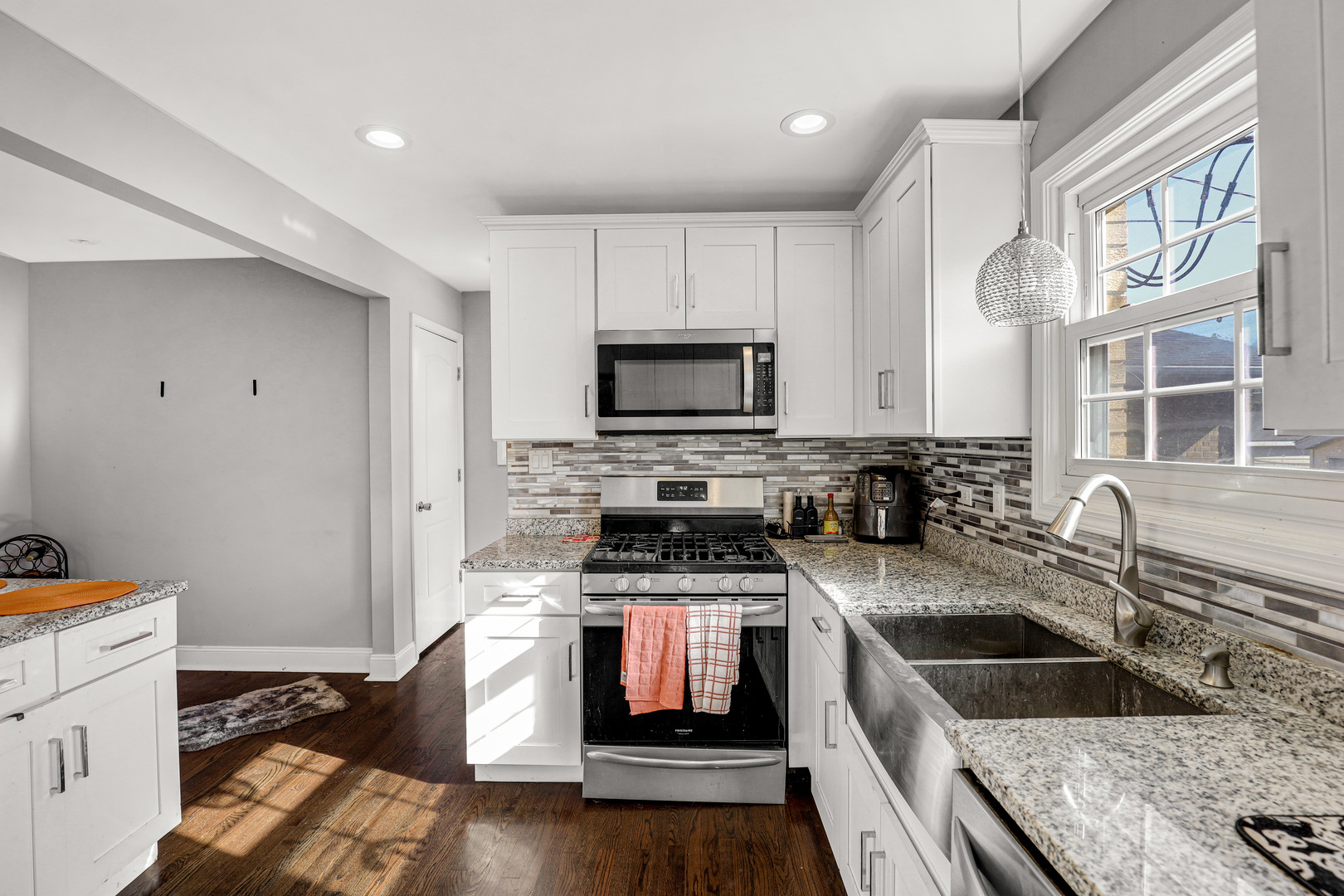 a kitchen with granite countertop a sink a counter space appliances and cabinets