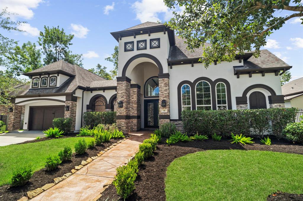 a front view of a house with a garden