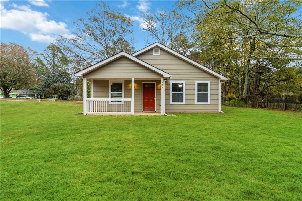 a view of a house with yard and tree s