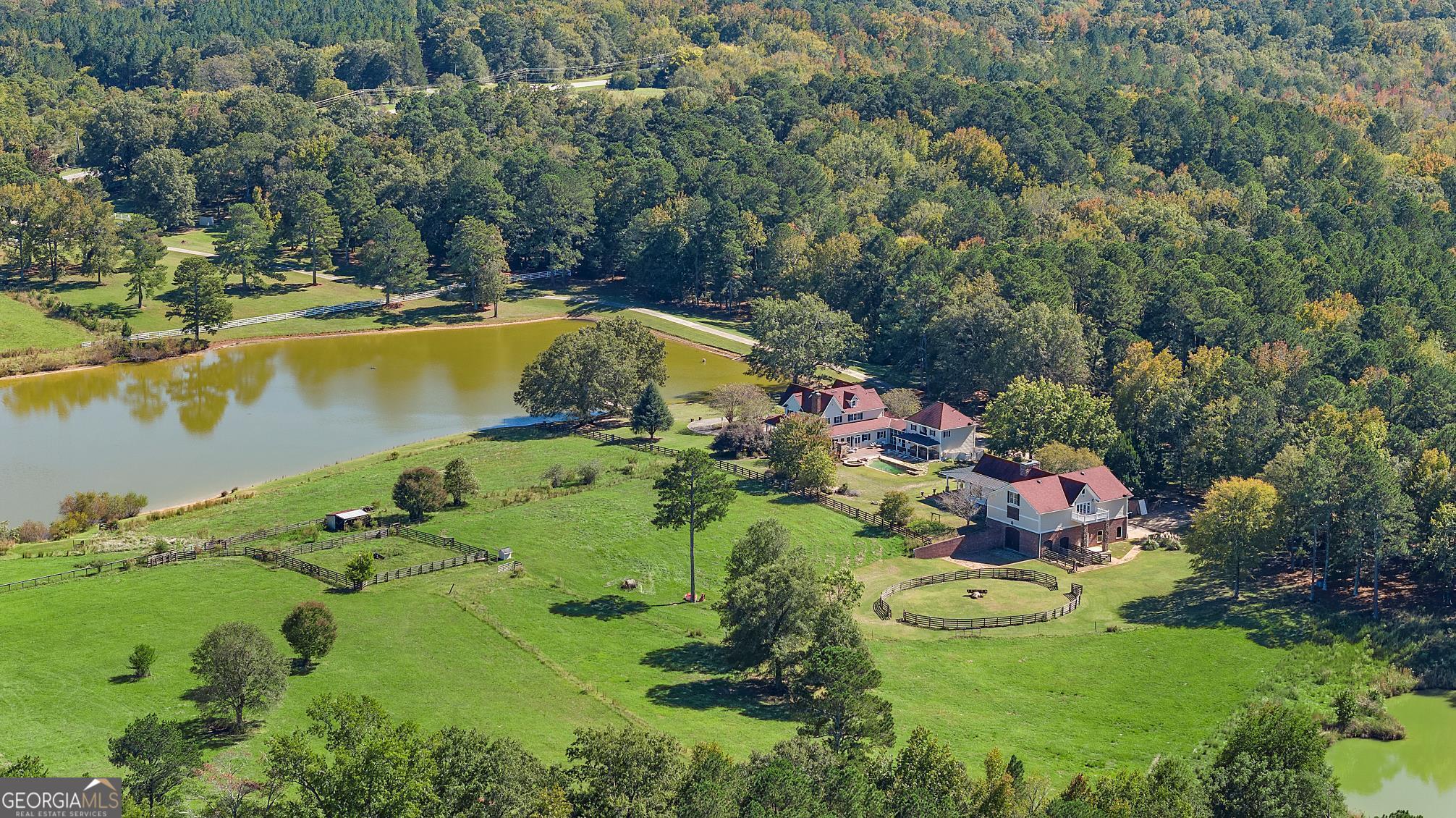 an aerial view of a house with a swimming pool yard and outdoor seating