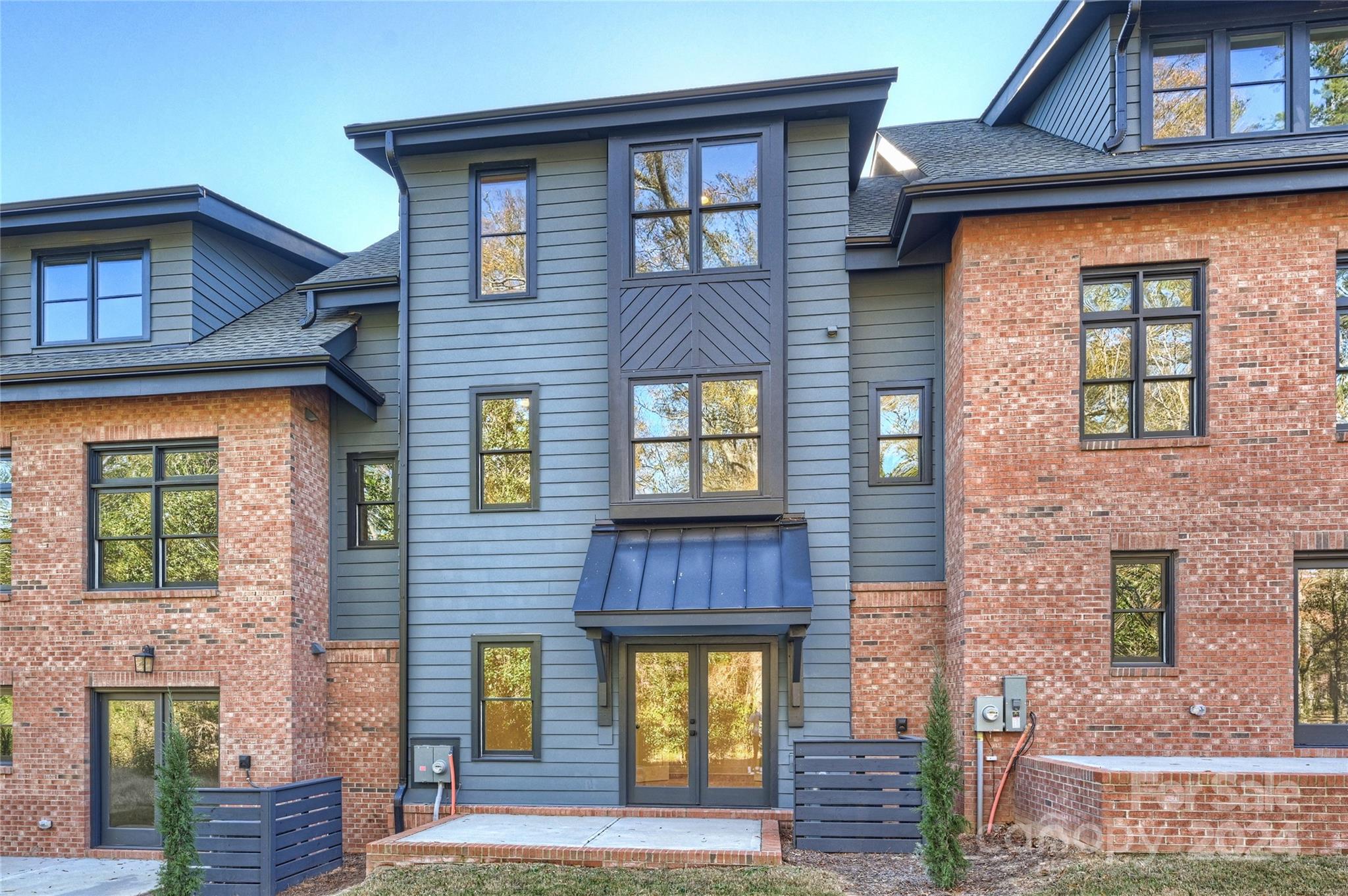 a view of a brick house with large windows