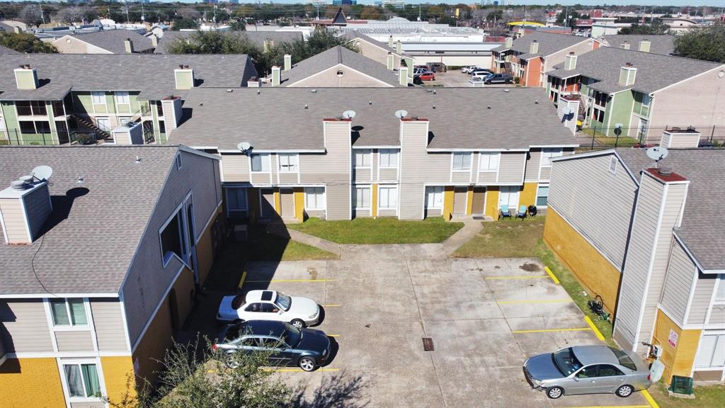 an aerial view of residential houses with yard