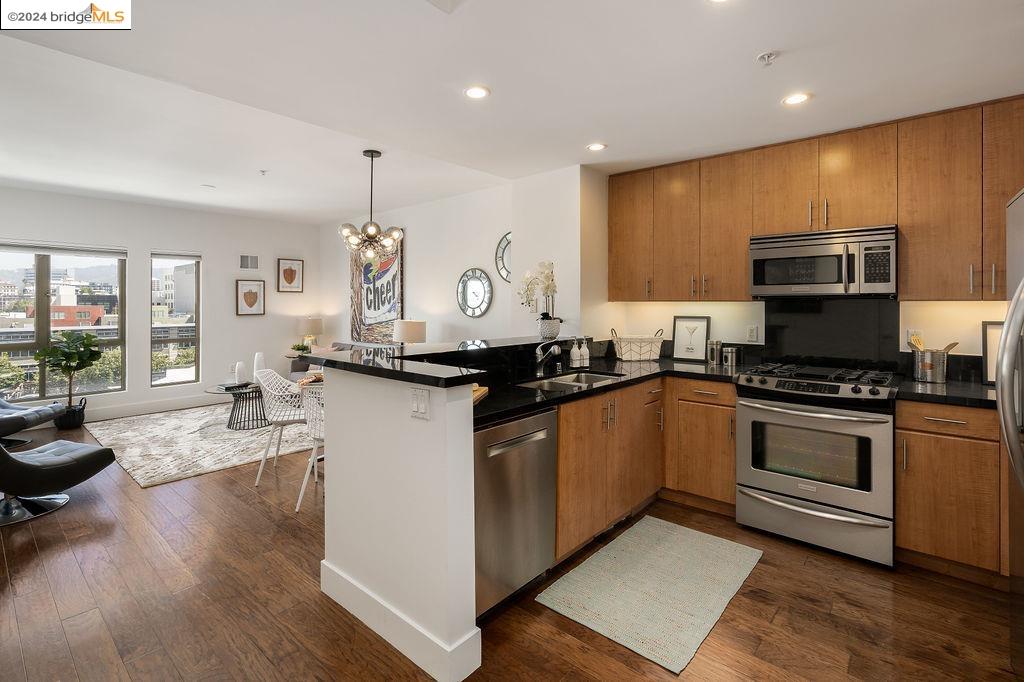 a kitchen with stainless steel appliances granite countertop a sink stove and cabinets